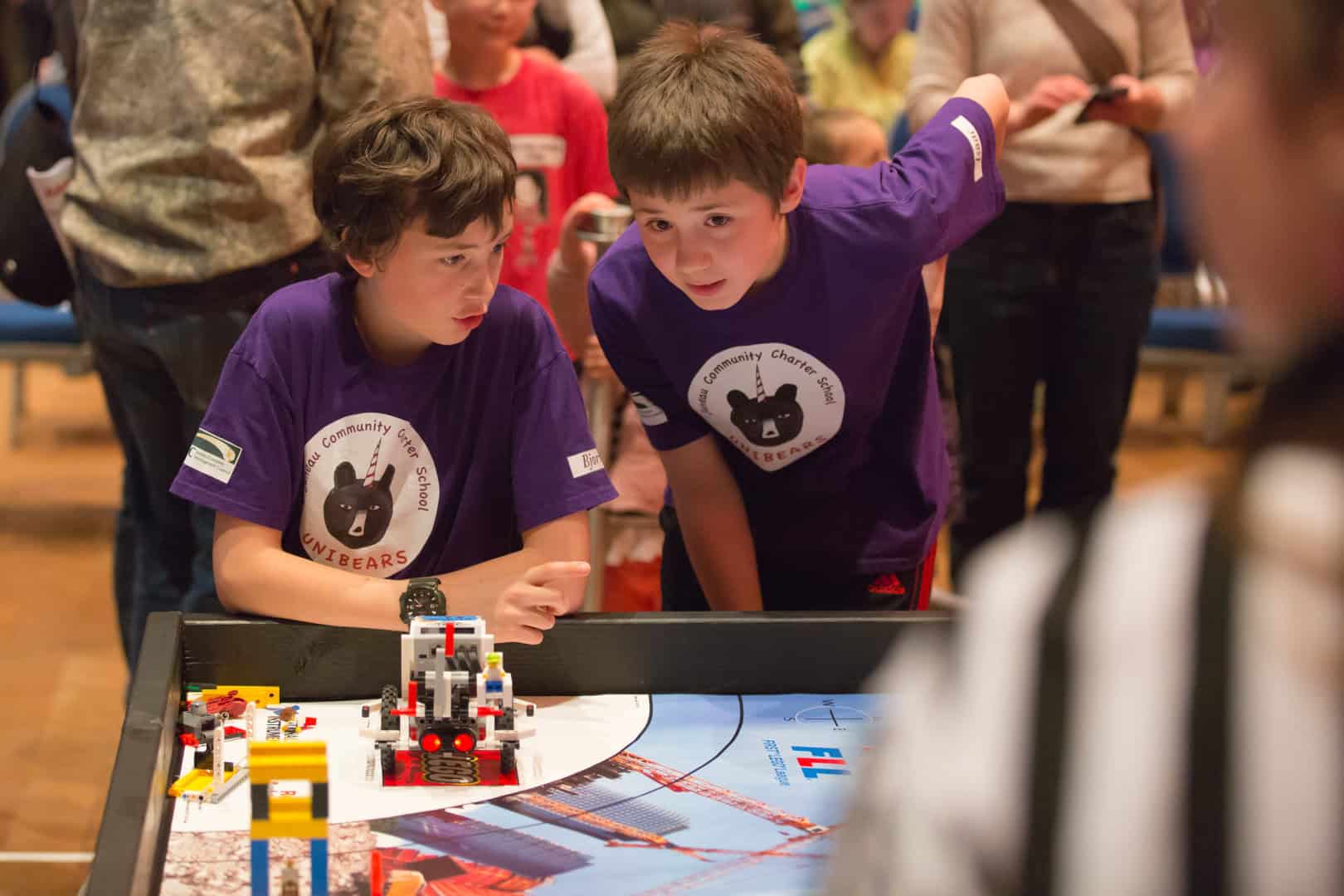 23562926350_b9e2c1b3be_o High Schoolers looking at robots they've built.