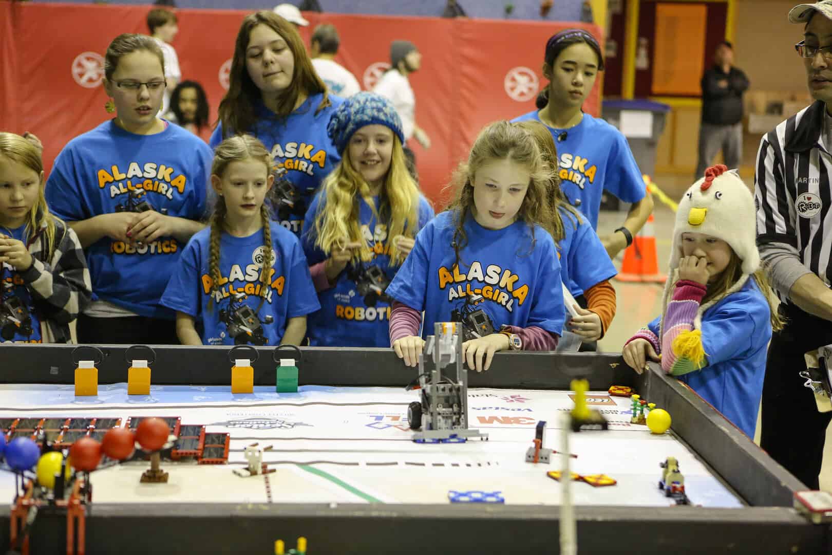 8267765876_3b2a105913_k Alaska All-Girls Robotics Team watches a robot moving attentively at a robotics competition.